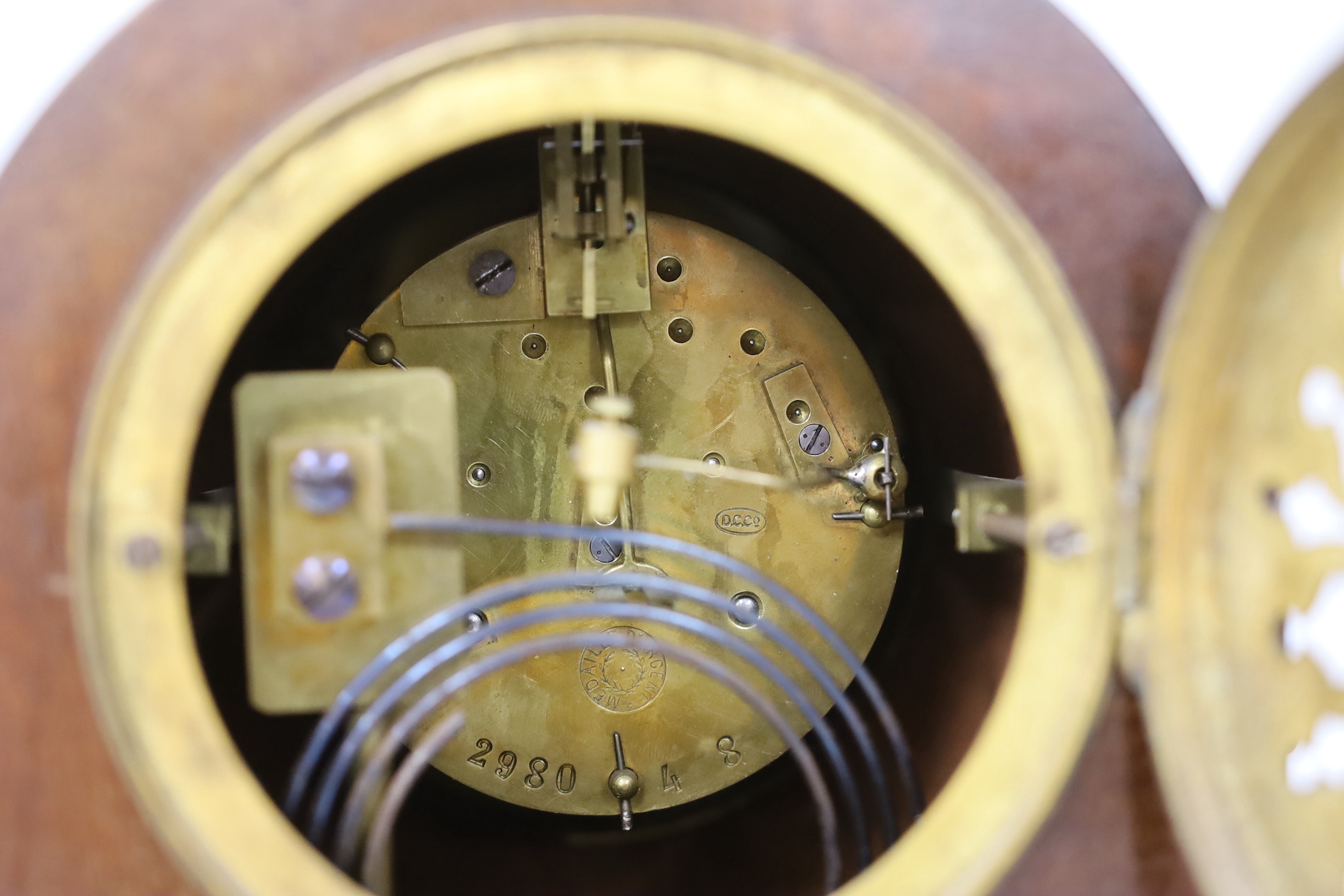 A brass presentation carriage clock together with an inlaid mahogany mantel clock